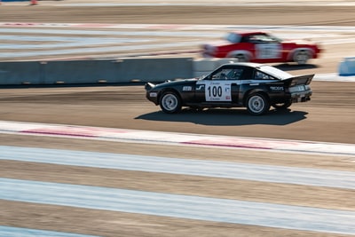 Black and red racing on the track
